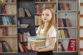 Child buys books in bookstore for learning or reading. Girl choosing book in school library Royalty Free Stock Photo