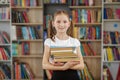 Child buys books in bookstore for learning or reading. Girl choosing book in school library Royalty Free Stock Photo