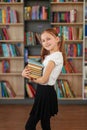 Child buys books in bookstore for learning or reading. Girl choosing book in school library Royalty Free Stock Photo