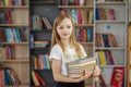 Child buys books in bookstore for learning or reading. Girl choosing book in school library Royalty Free Stock Photo