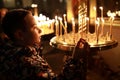 Child with candle in russian orthodox church