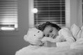 Child cannot sleep on bed at night in bedroom. Kid having sleeplessness. Kid boy sleeping in bed with night light. Royalty Free Stock Photo