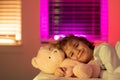 Child cannot sleep on bed at night in bedroom. Kid having sleeplessness. Kid boy sleeping in bed with night light.