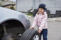 A child in a car service, on the replacement of tires and after-sales service of the vehicle. Auto repair concept