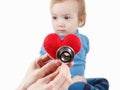 Child and cardiologist, heart symbol in hand, stethoscope.