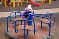 child on a carousel on the playground Royalty Free Stock Photo