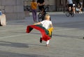 A child carries a fluttering tricolor Lithuanian flag outdoors. Kaunas Lithuania