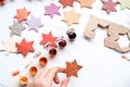 A child carves a star from cardboard. Christmas decoration, Christmas garland, hand made and Zero waste. Hands of a child on a