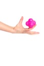 A child catches with one hand the magenta pink sports ball reaction on white background