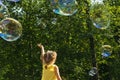 Child catches soap bubbles.