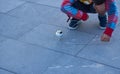 Child catching the spinning top with the rope