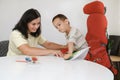 Child with cerebral palsy painting, mental physical problem, sensory therapy Royalty Free Stock Photo