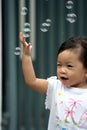 Child chasing bubbles Royalty Free Stock Photo