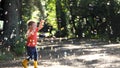 A child chasing Soap Bubbles in the wood Royalty Free Stock Photo