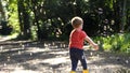 A child chasing Soap Bubbles in the wood Royalty Free Stock Photo