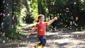 A child chasing Soap Bubbles in the wood Royalty Free Stock Photo