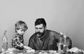 Child in checkered shirt carefully wipe table by sponge Royalty Free Stock Photo