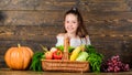 Child cheerful celebrate harvest holiday pumpkin vegetables basket. Harvest festival concept. Kid farmer with harvest