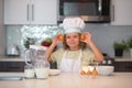 Child chef cook with eggs. Chef kid boy baking on the kitchen. Child chef cook prepares food at kitchen. Kids cooking Royalty Free Stock Photo