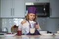 Child chef cooking meal. Child are preparing the dough, bake cookies in the kitchen. Royalty Free Stock Photo
