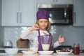 Child chef cooking meal. Chef child cook baking on the kitchen. Royalty Free Stock Photo