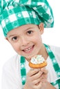 Child with chef hat holding muffin Royalty Free Stock Photo