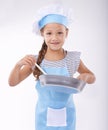 Child, chef and portrait with apron, confident and development on white background. Culinary skills, happy and learning