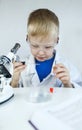 Child chemist. Teacher shows a visual experiment. A science mentor teaches an experimental approach. Microscope, petri dish,