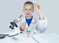 Child chemist. Teacher shows a visual experiment. A science mentor teaches an experimental approach. Microscope, petri dish, Royalty Free Stock Photo