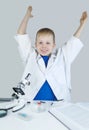 Child chemist. Teacher shows a visual experiment. A science mentor teaches an experimental approach. Microscope, petri dish, Royalty Free Stock Photo