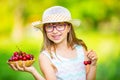 Child with cherries. Little girl with fresh cherries. Young cute caucasian blond girl wearing teeth braces and glasses. Royalty Free Stock Photo