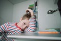 Child chewing on clothes while doing homework, stress, anxiety, mental problems Royalty Free Stock Photo