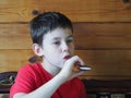 Child chews chocolate cake