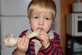 The child chews on a large bone