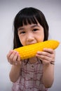 Child Eating a Corn Cob