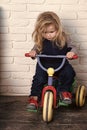 Child Childhood Children Happiness Concept. Boy riding bicycle in room Royalty Free Stock Photo