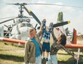 Child and childhood. Little child in mothers and fathers hands at military airfield. Cute child at air show outdoor