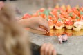 The child chooses a colorful miniature cake