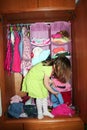 Child choosing dress in her wardrobe Royalty Free Stock Photo