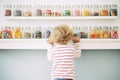 a child choosing from a variety of candy jars Royalty Free Stock Photo