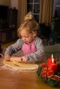 A child at Christmas in Advent when baking cookies Royalty Free Stock Photo