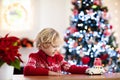 Child with Christmas present. Kid with Xmas gift Royalty Free Stock Photo