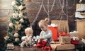 Child with a Christmas present on wooden background. Winter kids. Kid enjoy the holiday. Christmas card. New year kids