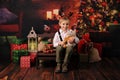 A child with Christmas presents and Christmas tree.