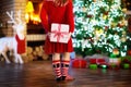 Child at Christmas tree. Kid at fireplace on Xmas Royalty Free Stock Photo