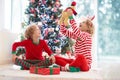 Child at Christmas tree. Kids at fireplace on Xmas Royalty Free Stock Photo