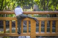 Child climbing a bridge fence by river or pond in a garden watching somthing Royalty Free Stock Photo