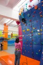 Child climbing an indoor artificial wall