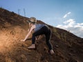 Child is climbing a mountain of sand. Royalty Free Stock Photo