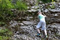 Child climbing rock in Khadzhokh gorge in summer Royalty Free Stock Photo